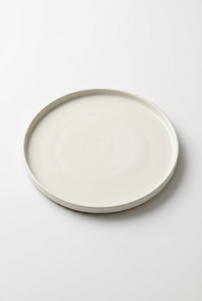 Vintage antiquewhite ceramic dinner plate on a seamless off-white studio background.